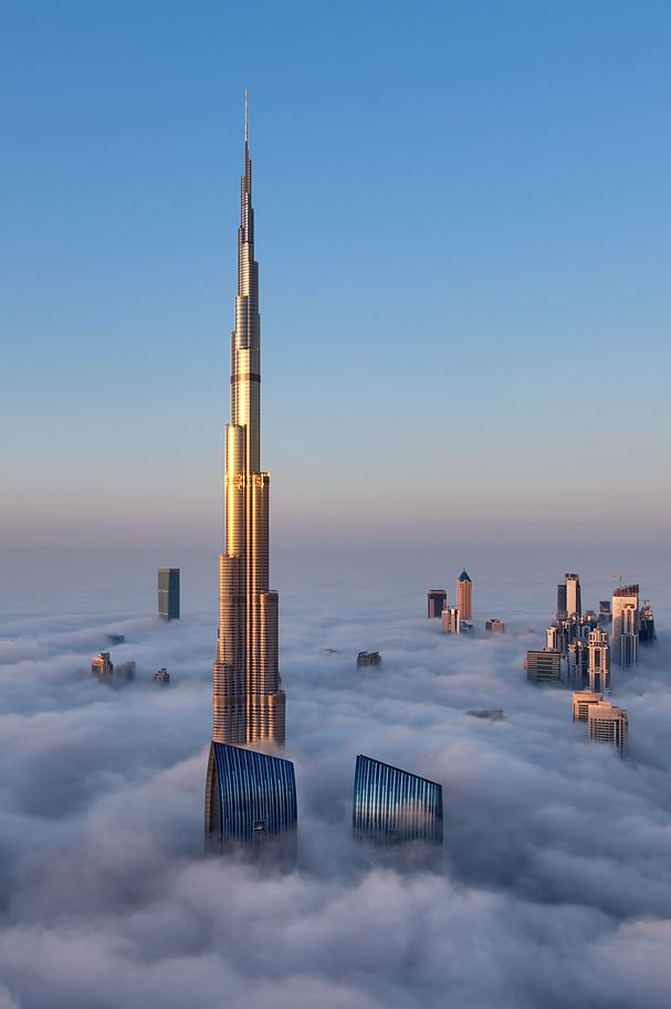 A close-up view of the majestic Burj Khalifa surrounded by a thick blanket of fog.